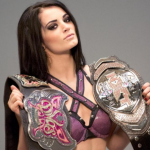 Paige holding two belts