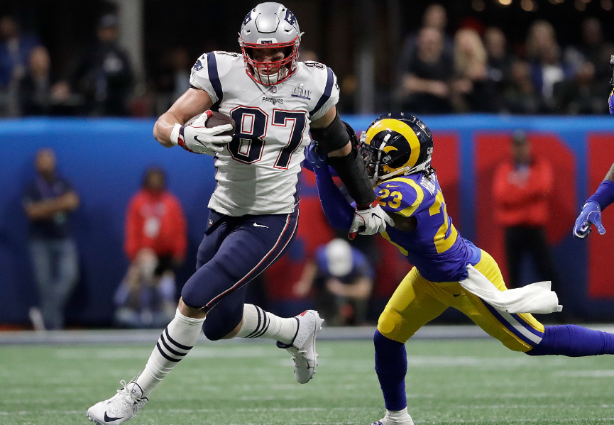 Rob Gronkowski Leading The Ball Against The Opponent