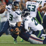 Russell Wilson Heading The Ball Against The Opponent