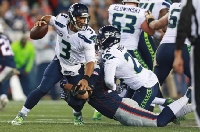 Russell Wilson Heading The Ball Against The Opponent