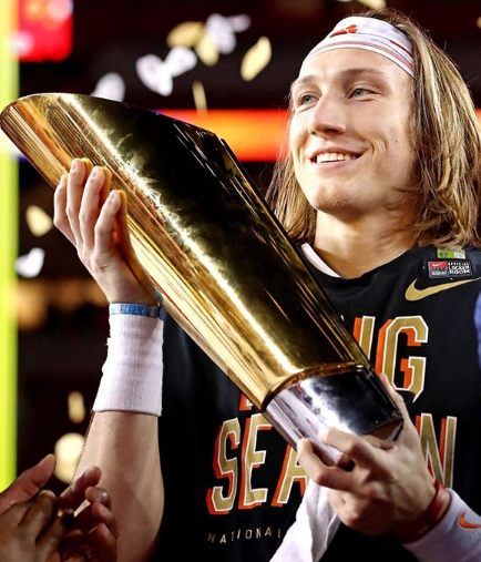 Trevor Lawrence Holding a Trophy