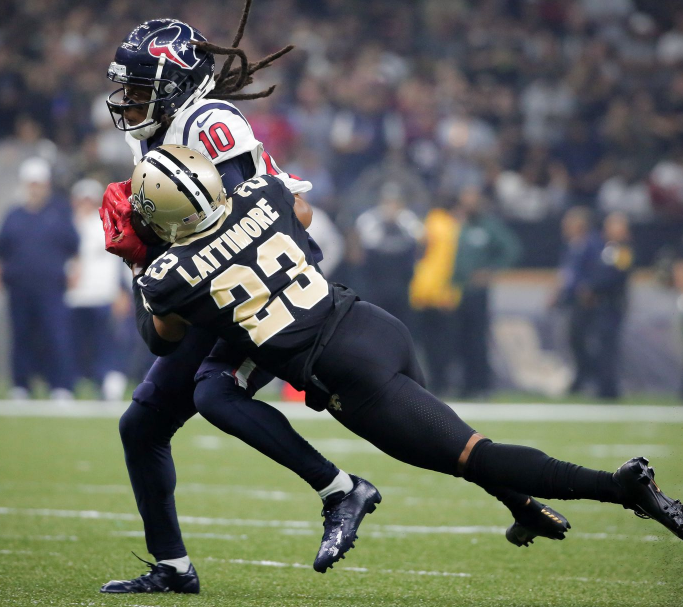 DeAndre Hopkins with the shirt number of 10 heading the ball against the opponent