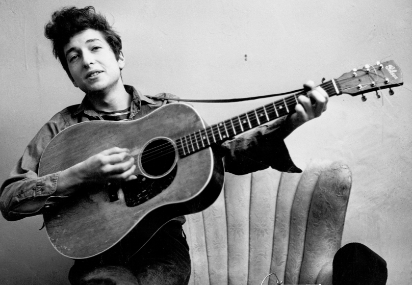 Bob Dylan at his young age with guitar