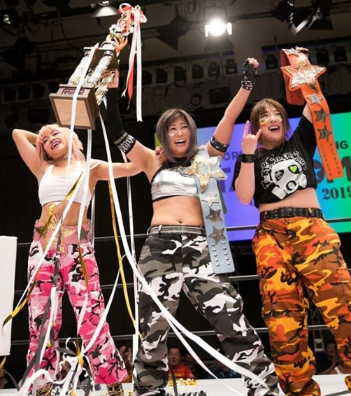 Hana Kimura with her Team Holding Trophy