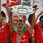 Thiago Alcantara of Bayern Munich lifts the trophy following the Bundesliga match between FC Bayern Muenchen and Eintracht Frankfurt in 2019