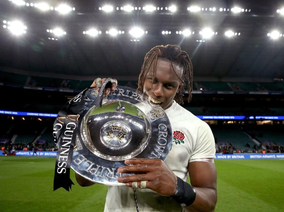 Maro Itoje Holding Triple Crown Shield