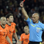 Referee Howard Webb of England, shows the red card to Netherlands' John Heitinga during the World Cup 2010 final soccer match