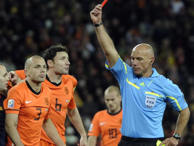 Referee Howard Webb of England, shows the red card to Netherlands' John Heitinga during the World Cup 2010 final soccer match